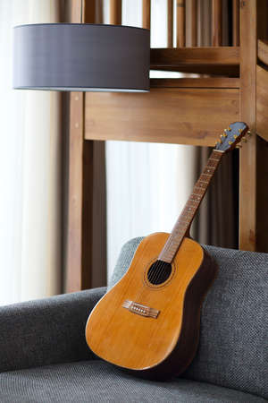 Cozy living room with guitar on the sofaの写真素材