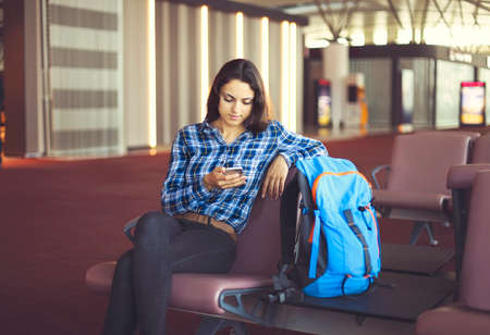 Woman passenger at the waiting area resting and waiting for her flight の写真素材