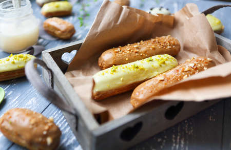 Eclairs with chocolate and whipped cream on dark background. Traditional French dessert. Top view.の写真素材