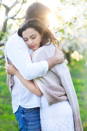 Young couple in love kissing and hugging in natureの写真素材