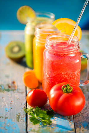 Three glasses of vegetable and fruit juiceの写真素材