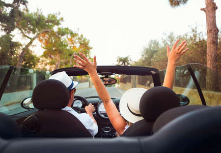 Happy Couple Driving on Country Road in Car