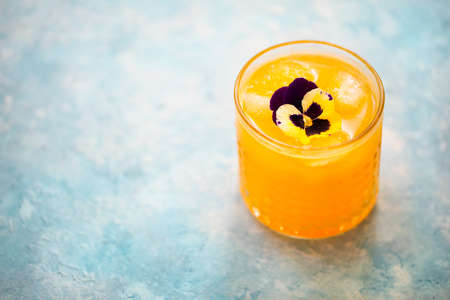 Alcohol orange cocktail on turquoise background