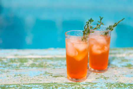 Alcohol orange cocktail on turquoise backgroundの写真素材
