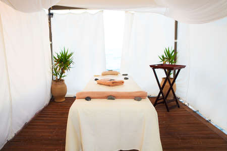 Massage table in the spa with sea view on the beachの写真素材