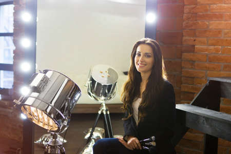 Make-up artist near mirror in stylish make-up roomの写真素材