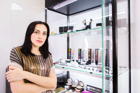 Young woman makeup artist with beautiful makeup in beauty salonの写真素材