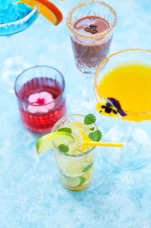 Alcohol cocktails on the turquoise background. Close upの写真素材