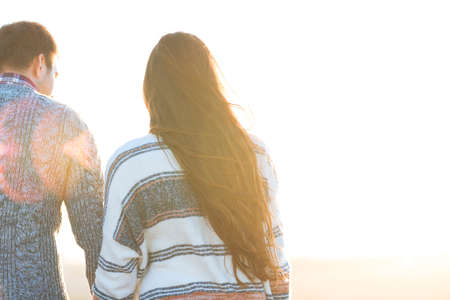 Young man and woman embrace outdoors on autumn sunset. Love and relationship conceptの写真素材