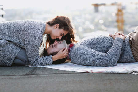 Young man and woman embrace outdoors on autumn sunset. Love and relationship conceptの写真素材