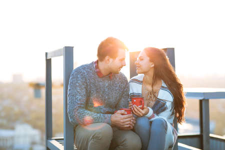 Young man and woman embrace and having fun outdoors on the roof& Love and relations conceptの写真素材