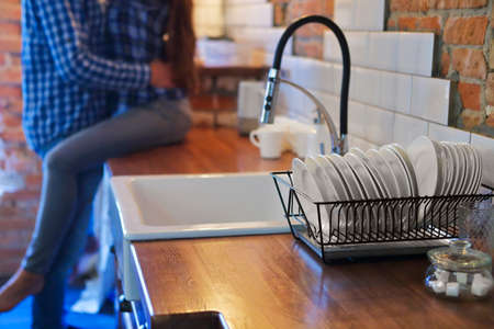 Young couple hugging and kissing at kitchen. Love and passion conceptの写真素材