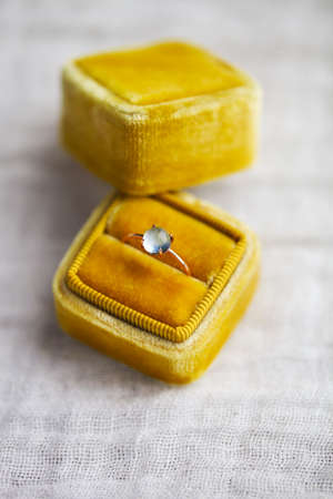 Engagement ring in the box on gray backgroundの写真素材