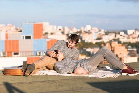 Young man and woman embrace outdoors on autumn sunset. Love and relationship conceptの写真素材