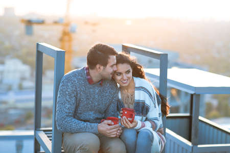 Young man and woman embrace and having fun outdoors on the roof& Love and relations conceptの写真素材