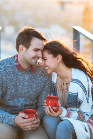 Young man and woman embrace and having fun outdoors on the roof& Love and relations conceptの写真素材
