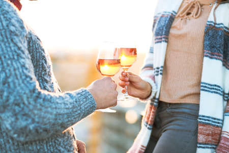 Man and woman with glass of rose wine on summer beach picnicの写真素材