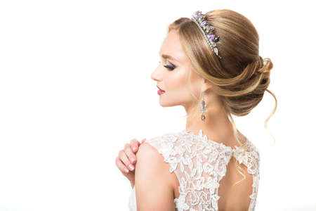 Young pretty caucasian bride in wedding dress at studioの写真素材