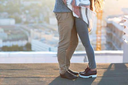 Young man and woman embrace and having fun outdoors on the roof Love and relations conceptの写真素材