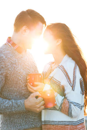 Young man and woman drinking  coffee outdoors Love and relations conceptの写真素材