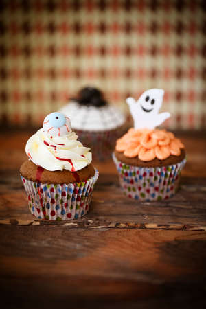 Halloween design homemade cupcake on dark backgroundの写真素材