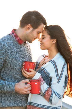 Young man and woman drinking  coffee outdoors Love and relations conceptの写真素材