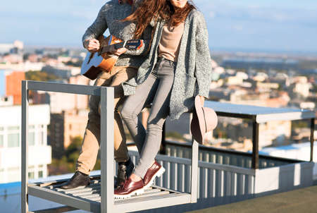 Young man and woman embrace and having fun outdoors on the roof Love and relations conceptの写真素材