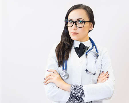 Young beautiful woman doctor on white background. Copy spaceの写真素材