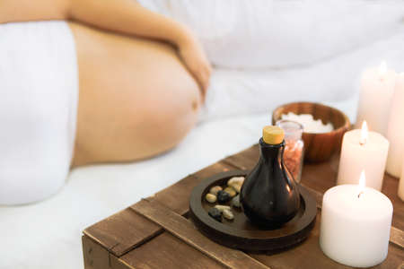 Young pregnant woman have massage treatment at spa salonの写真素材