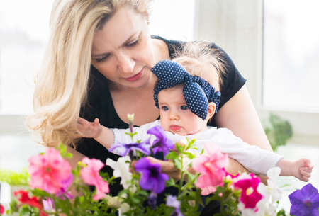 Mature woman embrace with baby girl. Grandmother and girl