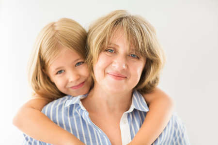 Mature woman embrace with young girl. Grandmother and girlの写真素材