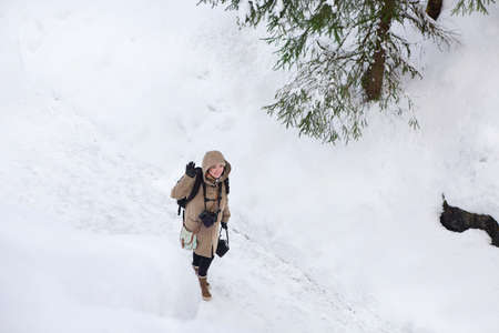 Professional female film photographer in Ruskeala marble quarry, Karelia, Russia