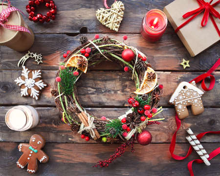 Christmas background with decorations, wreath, gift box and candlesの写真素材