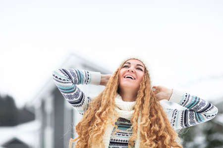 Young pretty smiling girl outdoors at winter snowy parkの写真素材