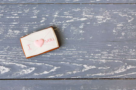 Pink and white romantic cookie on a gray wooden background with copy spaceの写真素材