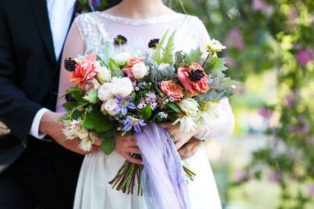Wedding ceremony. Groom and bride with bouquet. Close upの写真素材