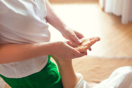 Young woman having massage treatment in health centre.の写真素材