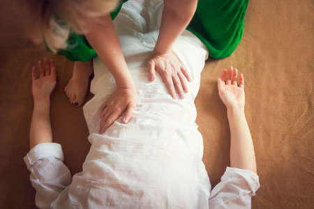 Young woman having massage treatment in health centre.