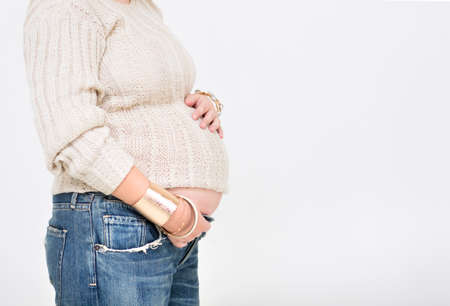 Pretty pregnant woman indoors on white background