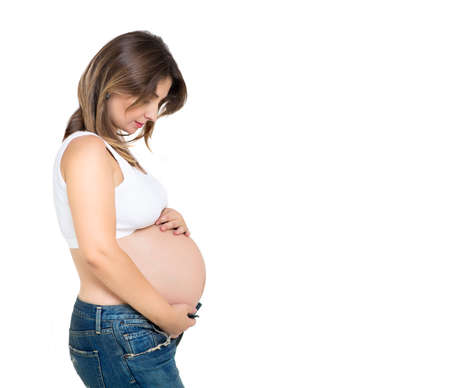 Pretty pregnant woman indoors on white background