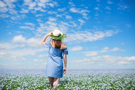 Young beautiful woman in summer linen fieldの写真素材