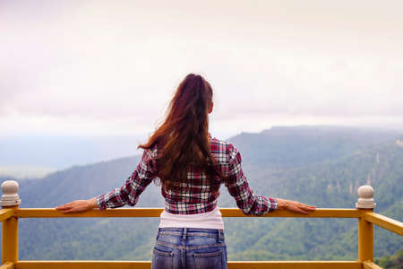 Beautiful brunette woman in summer mountain tripの写真素材