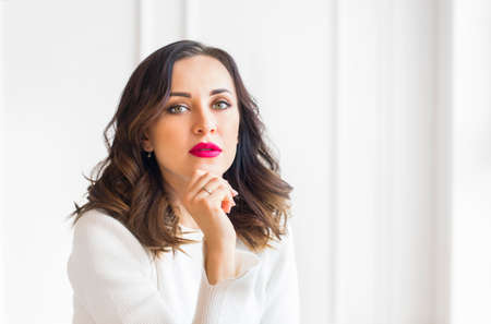 Stylish young female portrait on white wall background の写真素材