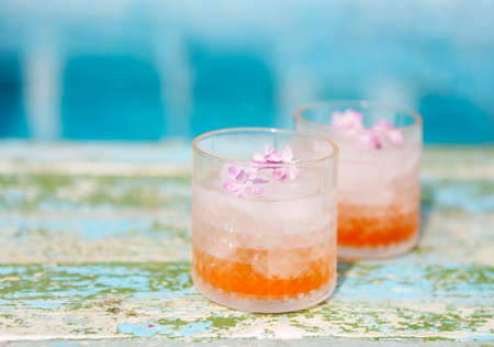 Lilac lemonade water with flowers by the poolの写真素材