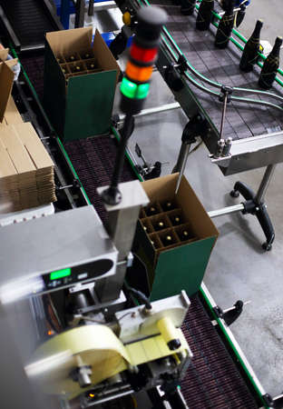 Industrial production shot with champagne bottles on the conveyor belt in a factory 