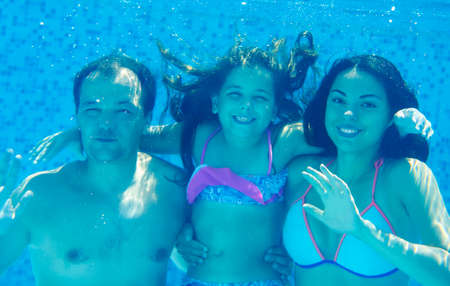 Happy family In Swimming Pool. Underwater portraitの写真素材