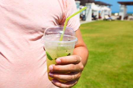 Happy young man in with mojito cocktail. Summer holidays vacation. Close upの写真素材