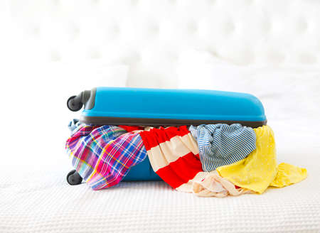 Anticipation of voyage. Clothes and accessories in turquoise suitcase