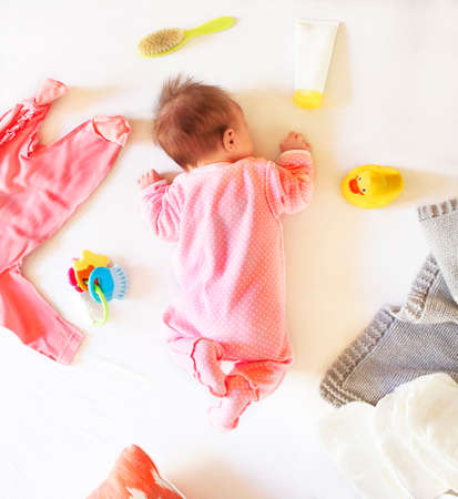 Baby girl is sleeping on the bed. Newborn baby girl
