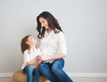 Young happy woman embrace with small daughter. Love and family concept の写真素材